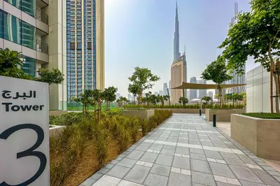 a walkway in the middle of a city with buildings at Luxurious 2BR in Downtown Views II, Zaabeel Second in Dubai