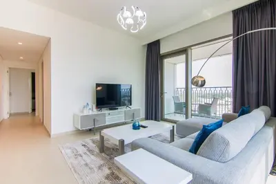 a living room with a couch and a tv at Luxurious 2BR in Downtown Views II, Zaabeel Second in Dubai