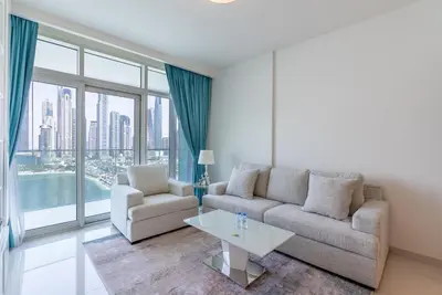a living room with a couch and a table at Luxury Living with Private Beach in Dubai