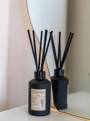 two black vases with sticks in them on a table at Chic 4 Bedroom Apartment I Burj Khalifa & Fountain Views I Direct Access to Dubai Mall I Free Gym, Pool, Parking Wi-Fi and PS5 I by Skyline Serenity in Dubai