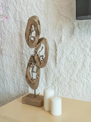 a metal sculpture on a table next to two candles at Chic 4 Bedroom Apartment I Burj Khalifa & Fountain Views I Direct Access to Dubai Mall I Free Gym, Pool, Parking Wi-Fi and PS5 I by Skyline Serenity in Dubai
