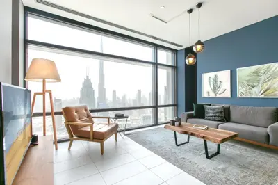 a living room with a couch and a tv at Blueground DIFC pool gym DXB-468 in Dubai