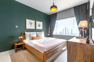 a bedroom with a bed and a large window at Blueground DIFC pool gym DXB-468 in Dubai