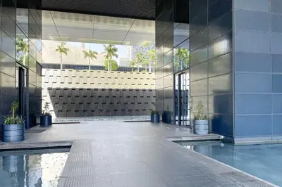 a lobby of a building with a pool of water at Blueground DIFC pool gym DXB-468 in Dubai