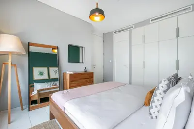 a bedroom with a bed and a mirror at Blueground DIFC pool gym DXB-468 in Dubai