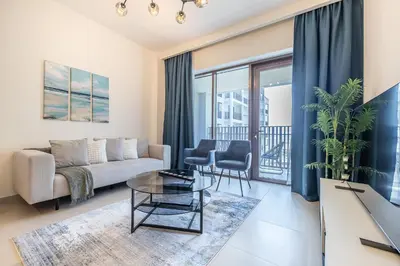 a living room with a couch and a table at Exquisite 1BDR apartment in Creek with Pool View in Dubai