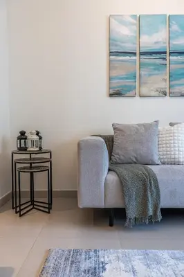 a living room with a couch and a table at Exquisite 1BDR apartment in Creek with Pool View in Dubai