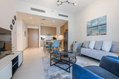 a living room with a couch and a table at Exquisite 1BDR apartment in Creek with Pool View in Dubai