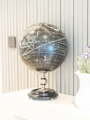 a globe on top of a table with a vase at Lavish 2 Bedroom I Burj Khalifa & Fountain Views I Free Gym, Pool, Parking, Wi-Fi and PS5 I by Skyline Serenity in Dubai