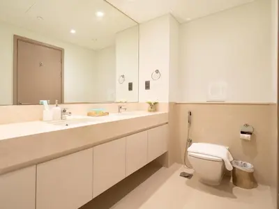 a bathroom with a toilet and a large mirror at Skyline 2 Bedroom Apartment I Burj Khalifa & Fountain Views I Free Gym, Pool, Parking, Wi-Fi and PS5 in Dubai