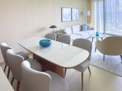a living room with a white table and chairs at ADDRESS Residences Opera 2BR Tower 1 - EPIC 30th floor Burj Khalifa view byBLCK with DXB AIRPORT VIP Shuttle option in Dubai