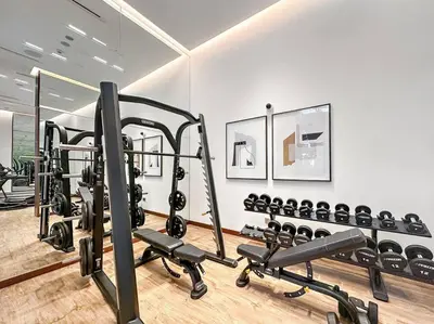 a gym with a row of treadmills and machines at Chic 2BR Vida Stay, Creek Views & Prime Location Near Attractions in Dubai
