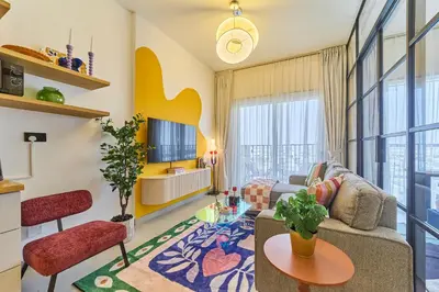 a living room with a couch and a table at Colorful1BR Apartment in Dubai Hills Next to Mall in Dubai