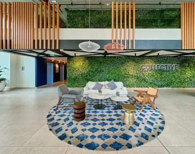 a lobby with a couch and a table and chairs at Colorful1BR Apartment in Dubai Hills Next to Mall in Dubai