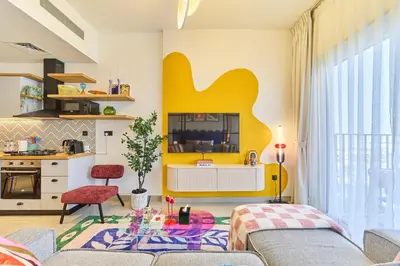 a living room with a couch and a table at Colorful1BR Apartment in Dubai Hills Next to Mall in Dubai