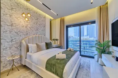 a bedroom with a bed and a large window at Bright Studio in Azizi Riviera Perfect Getaway in Dubai