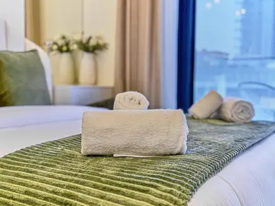 a towel sitting on top of a bed at Bright Studio in Azizi Riviera Perfect Getaway in Dubai