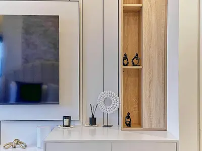 a white cabinet with some knick knacks on it at Bright Studio in Azizi Riviera Perfect Getaway in Dubai