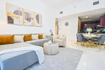 a living room with a couch and a dining room at Iconic Sea View Marina - LUX NEW in Dubai