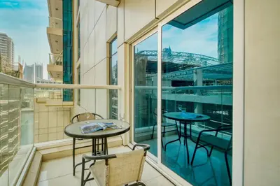 a balcony with two tables and a view of the city at ShoresInn - Elite 1BR in Dubai Marina in Dubai