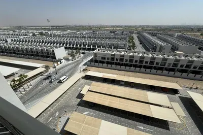 an overhead view of a large building with a parking lot at Brand New Studio 15 mins drive from Business Bay in Dubai