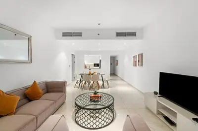 a living room with a couch and a table at FIRST CLASS 3BR Stylish Sanctuary in Dubai