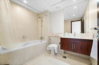 a bathroom with a tub and a toilet and a sink at Ace Luxe, 2BR, Downtown, Burj Khalifa & Dubai Fountain view, 5 mins walk to Dubai Mall in Dubai