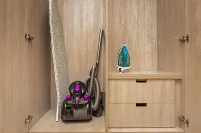 a mop sitting on a shelf in a room at Lovely 1BR in Seven Palm in Dubai