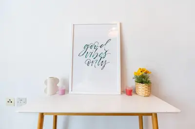 a white shelf with a picture and a painting on it at Central 1BR in Marina with Private Terrace & Pool in Dubai