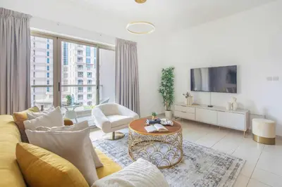 a living room with a couch and a tv at Frank Porter - Al Arta 4 in Dubai