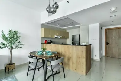 a kitchen and dining room with a table and chairs at ShoresInn - Stellar 2BR with charming Marina View in Dubai