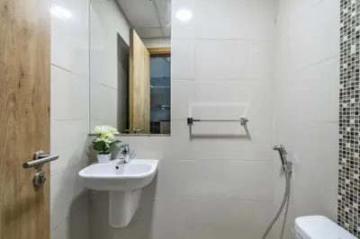 a white bathroom with a sink and a mirror at ShoresInn - Stellar 2BR with charming Marina View in Dubai