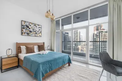 a bedroom with a bed and a large window at ShoresInn - Stellar 2BR with charming Marina View in Dubai