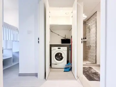 a laundry room with a washer and dryer at Cozy 1 Bedroom in Golfville Dubai Hills in Dubai