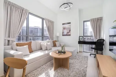 a white living room with a white couch and a piano at Mystic - Stylish High-Rise Living with Premium Amenities in Dubai