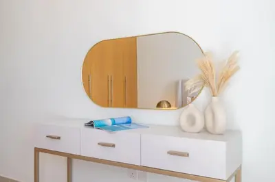 a white dresser with a mirror on top of it at Mystic - Stylish High-Rise Living with Premium Amenities in Dubai