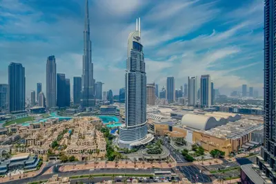 an aerial view of a city with a tall skyscraper at Burj Royale - Luxury Stay with Panoramic Burj Khalifa & Fountain View in Dubai