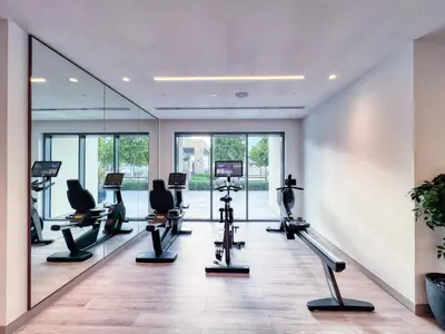a gym with treadmills and elliptical machines at Burj Royale - Luxury Stay with Panoramic Burj Khalifa & Fountain View in Dubai