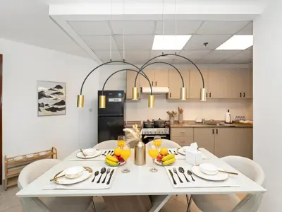 a kitchen with a white table with fruit on it at Stunning Panoramic Sea & Marina Skyline View in Dubai