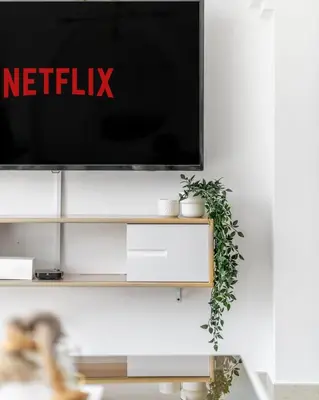 a tv on a wall with a netflix sign on it at GuestReady - Downtown lux near Burj Khalifa in Dubai