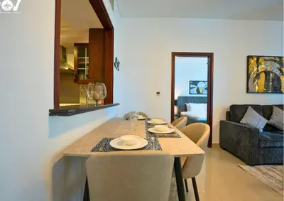 a table in a living room with a dining room at Luxurious 2BR I Burj Khalifa View I Downtown Dubai in Dubai