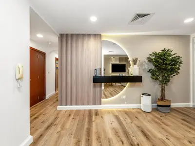 a living room with a table and a potted plant at Elegant Dubai Eye Beach Retreat in Dubai