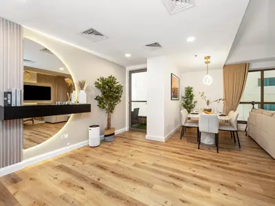 a living room with a table and a couch at Elegant Dubai Eye Beach Retreat in Dubai