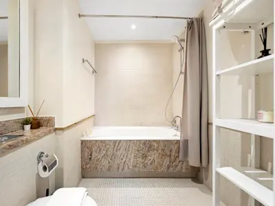 a bathroom with a tub and a sink at Bespoke 1 Bedroom Apartment I Burj Khalifa & Fountain Views I Free Gym, Pool, Wi-Fi, Parking & PS5 I by Skyline Serenity in Dubai