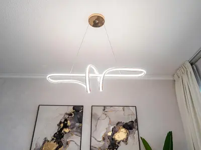 a chandelier hanging from a ceiling in a room at Luxe 4 bedroom Apartment I Burj Khalifa & Fountain Views I Free Gym, Pool, Parking, Wi-Fi and PS5 I by Skyline Serenity in Dubai