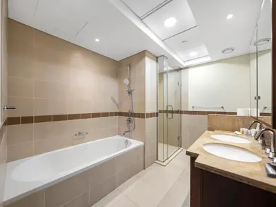 a bathroom with a tub and two sinks and a shower at New Burj Khalifa & Fountain Views & Work station in Dubai