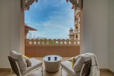 a room with two chairs and a table and a window at The Smart Concierge - Grandeur Residence - Maurya in Dubai