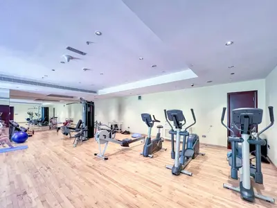 a gym with treadmills and exercise equipment in a room at The Smart Concierge - Grandeur Residence - Maurya in Dubai