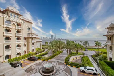 a view of a building and a street with palm trees at The Smart Concierge - Grandeur Residence - Maurya in Dubai