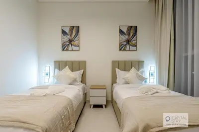 two beds sitting next to each other in a bedroom at 2 Bed Apt in District One Dubai - Lagoon Views in Dubai